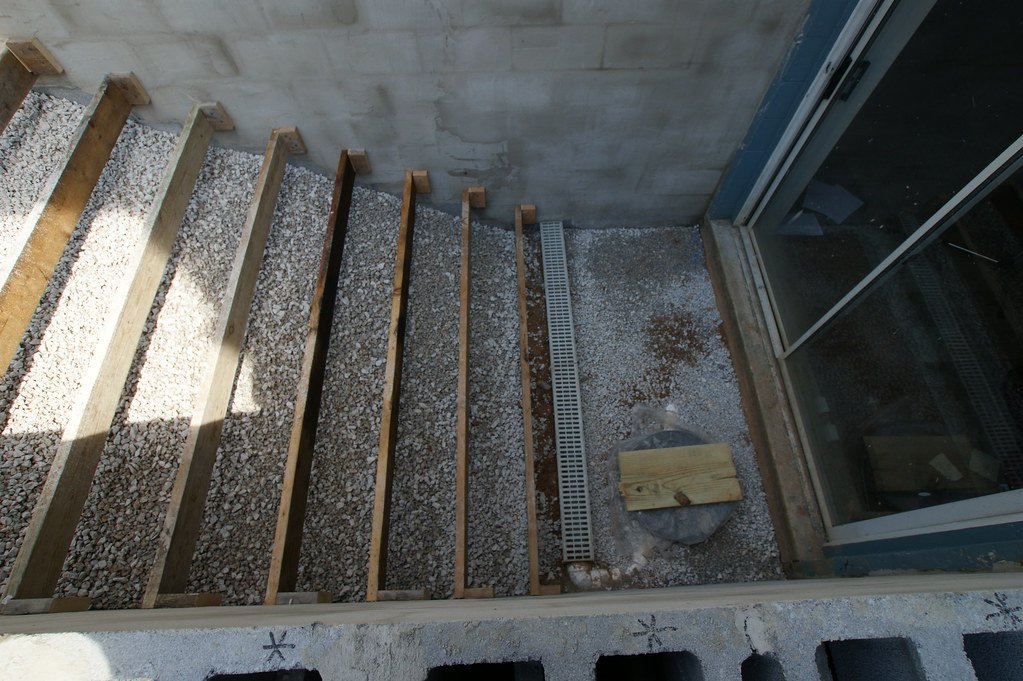 DURING- A trench drain was installed to eliminate the cloggi
