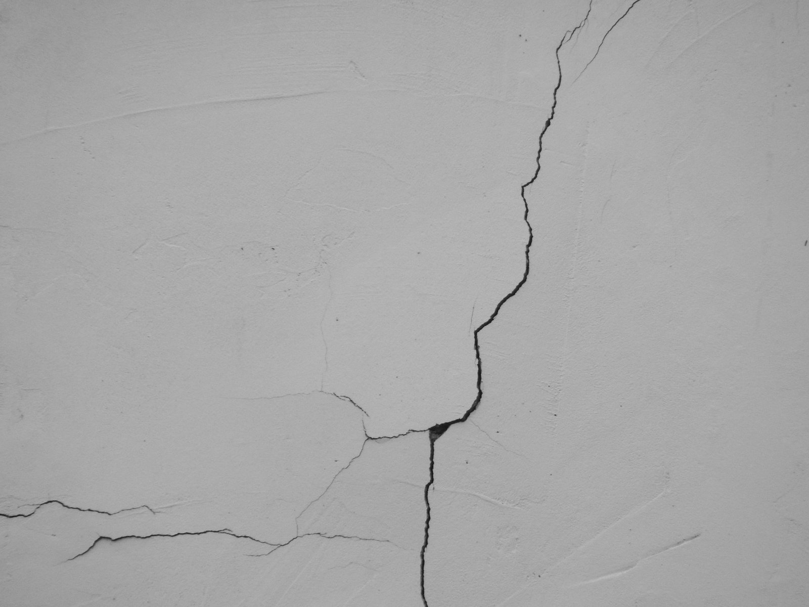 a crack in the side of a white wall